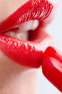 Buy stock photo Closeup shot of a woman applying vibrant red lipstick to her lips isolated on white