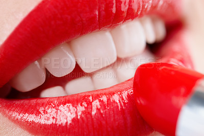 Buy stock photo Closeup shot of a woman applying vibrant red lipstick to her lips 