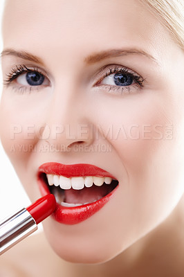Buy stock photo Closeup portrait of a woman applying vibrant red lipstick to her lips isolated on white