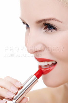 Buy stock photo Closeup shot of a young woman applying vibrant red lipstick to her lips isolated on white
