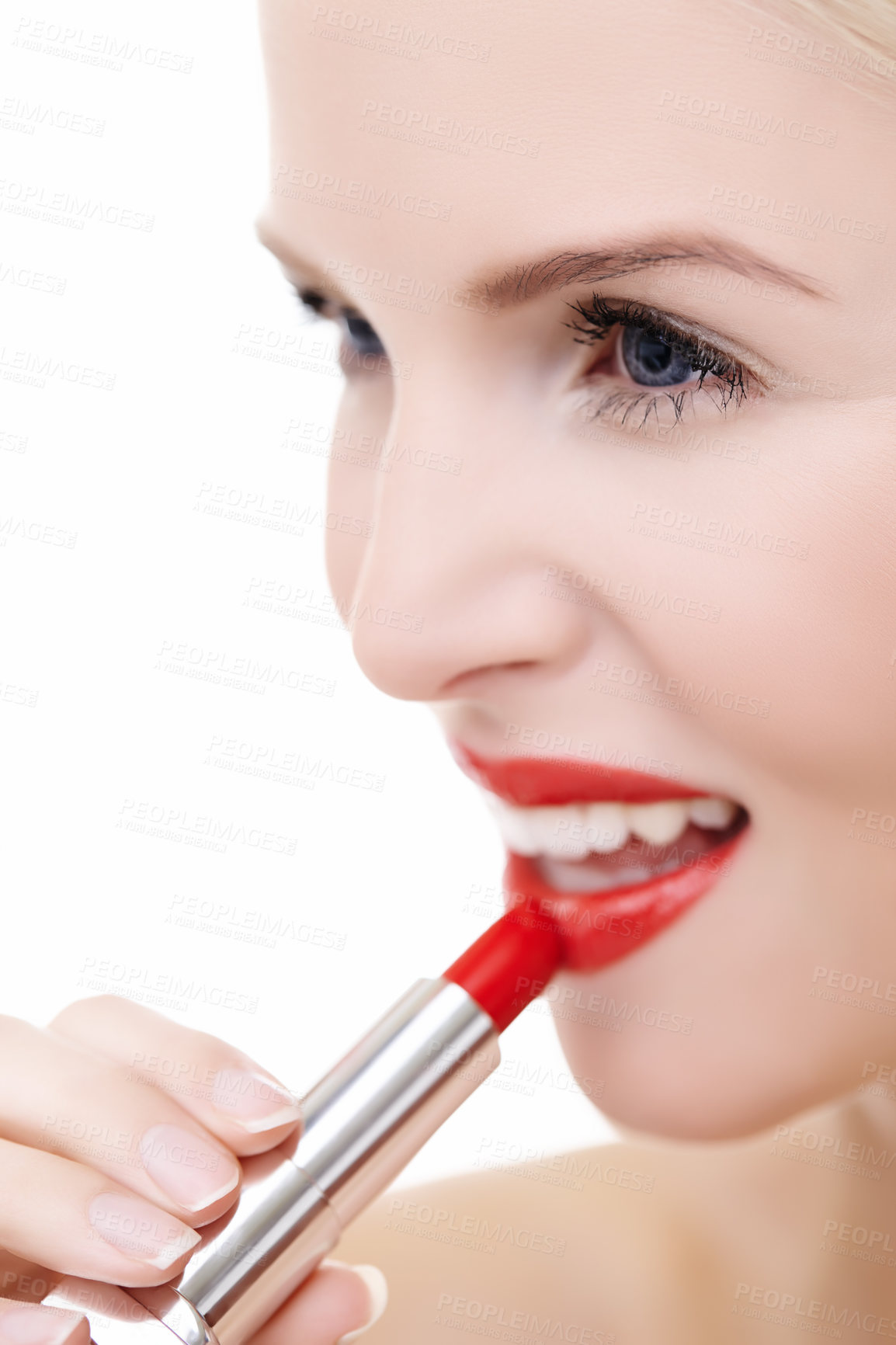 Buy stock photo Closeup shot of a young woman applying vibrant red lipstick to her lips isolated on white