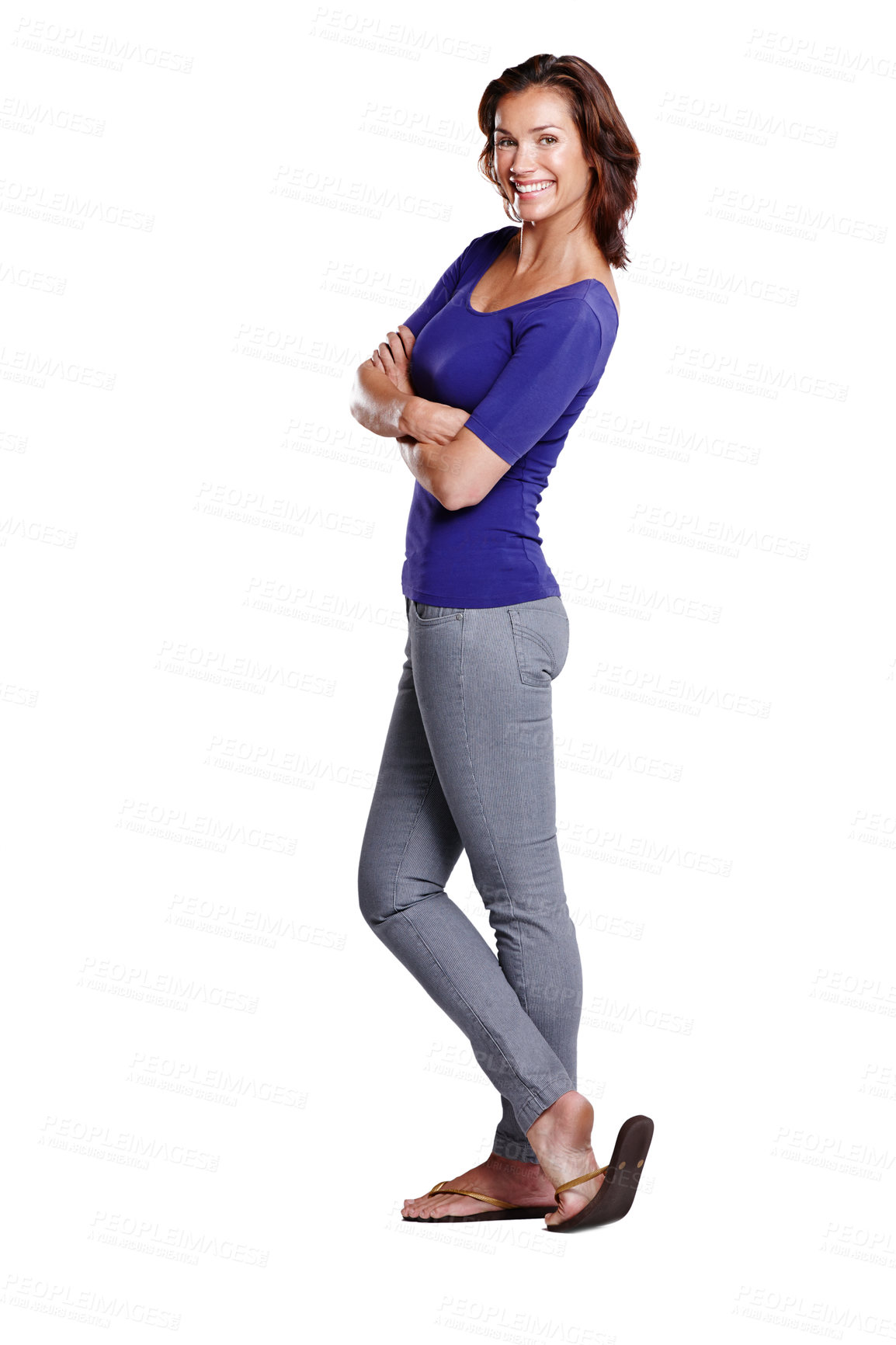 Buy stock photo Confident and edgy caucasian female standing isolated against a white background. Beautiful happy young woman with an attitude and bright smile. Portrait of attractive and positive lady arms folded