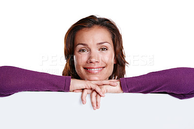 Buy stock photo Happy, poster and woman in studio with mockup space for advertising, marketing or promotion. Billboard, smile and portrait of female person with blank paper for sign isolated by white background