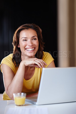 Buy stock photo Woman, happy and laptop in home with juice for remote work, online research and project planning by table. Freelancer, copywriter and smile with technology for blog writing and internet browsing