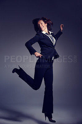 Buy stock photo Smile, corporate and business woman jumping in studio on a grey background for comedy or humor. Comic, funny and a confident young employee looking happy at fashion joke as professional in suit