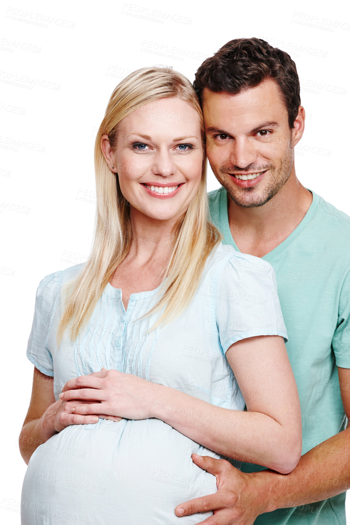 Buy stock photo A smiling husband holding his pregnant wife's stomach from behind 