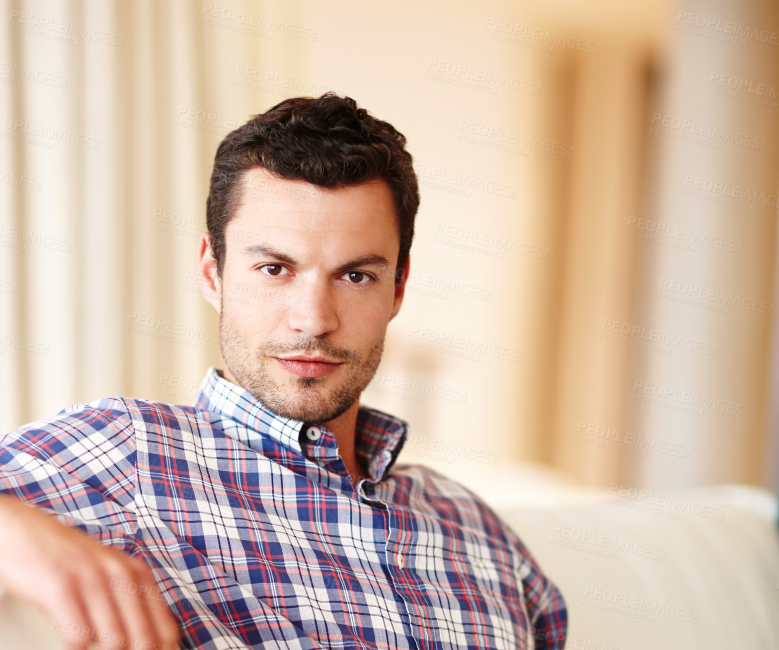 Buy stock photo Casual, chill and portrait of man in house living room on comfortable couch to relax alone. Face, apartment and serious male person on sofa in home for peace, break and resting on day off in Spain