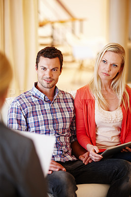 Buy stock photo A happy couple getting advice from a financial consultant in their home