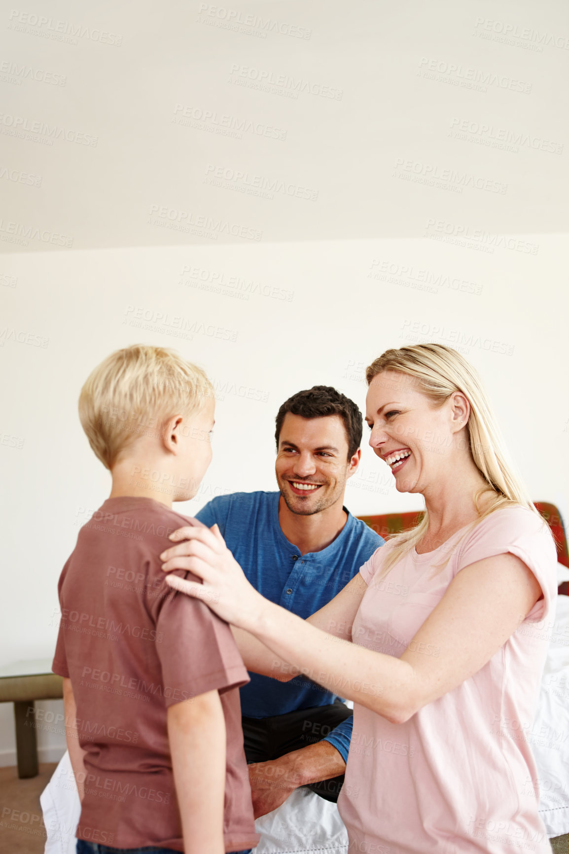 Buy stock photo A happy mother and father doting over their son 