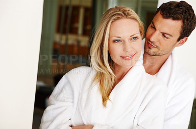 Buy stock photo Couple, hug and care in home for love in relationship, romance and weekend date in hotel. People, embrace and together for affection in marriage, bonding and support in bathrobe or morning smile