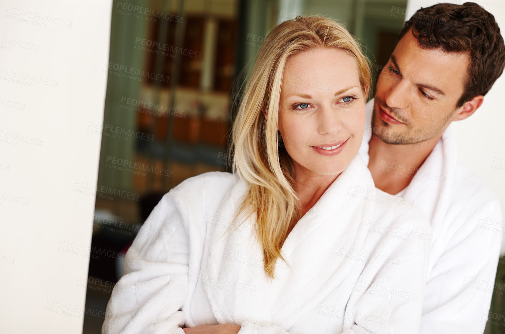 Buy stock photo Couple, hug and care in home for love in relationship, romance and weekend date in hotel. People, embrace and together for affection in marriage, bonding and support in bathrobe or morning smile