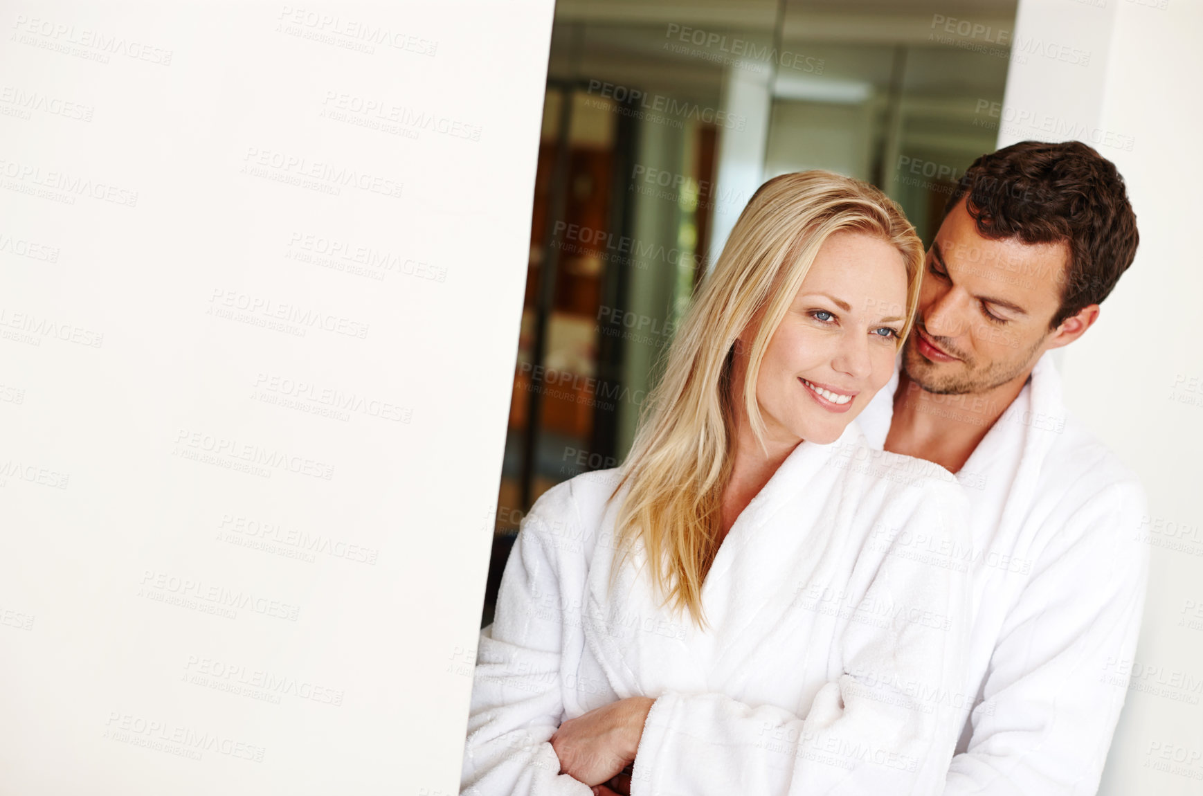 Buy stock photo Couple, hug and calm in home for love in relationship, romance and weekend date in hotel. People, embrace and together for affection in marriage, bonding and support in bathrobe on mockup space