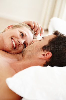 Buy stock photo A loving young couple resting in bed together