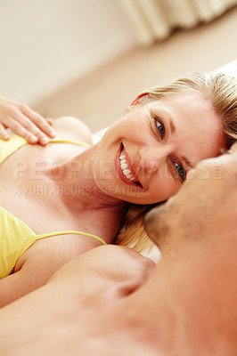 Buy stock photo A loving young couple resting in bed together