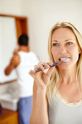 Buy stock photo Couple, routine and brushing teeth in bathroom in morning for love, bonding and hygiene with toothbrush. Man, woman and dental care in house together for cleaning mouth, relationship and 