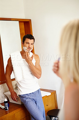 Buy stock photo Man, shaving and cream by mirror in bathroom in morning for love, bonding and hygiene with wife. Couple, marriage and grooming routine in house together for cleaning, relationship and fresh start