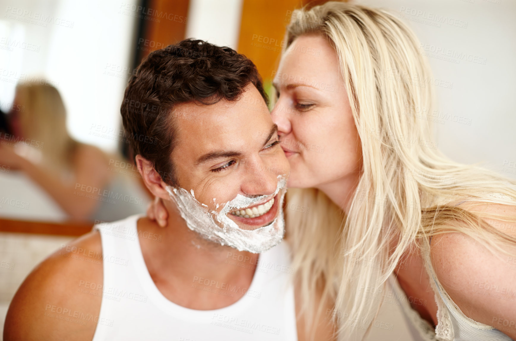 Buy stock photo Shaving, kiss and couple in bathroom with smile, romance and getting ready for beard care. Love, happy woman and man with bonding, foam and hair removal in morning cleaning routine at home together