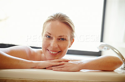 Buy stock photo A gorgeous young woman relaxing happily in a bathtub