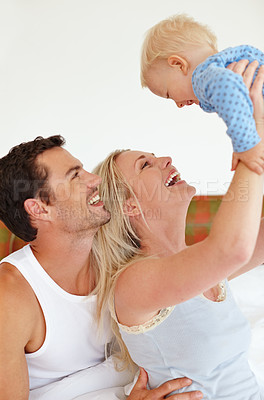 Buy stock photo Love, airplane and parents lifting baby in bedroom with fun, bonding and playing morning games at home together. Family, learning or people in house with security, trust or care for child development