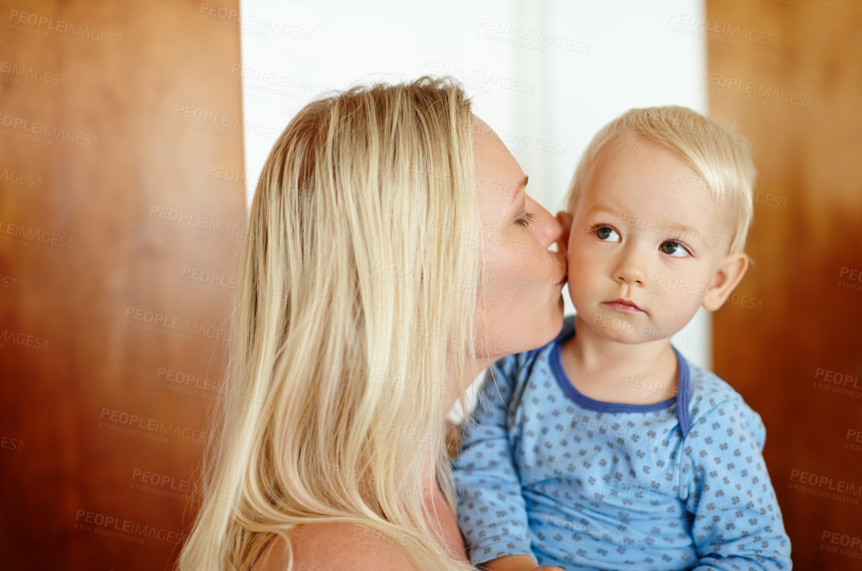 Buy stock photo Kiss, love or security with mother and son in home together for morning bonding or trust. Face, happy or safety with woman single parent and boy child in apartment for relationship or support