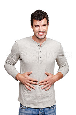 Buy stock photo Hungry, sick and portrait of a man with a stomach problem isolated on a white background in studio. Stress, pain and person with a stomachache, abdominal pain or painful ibs on a studio background