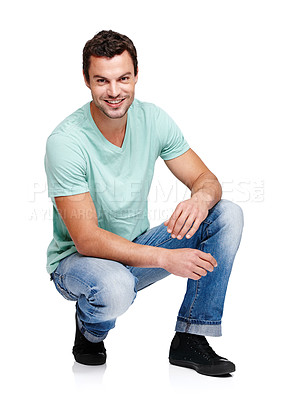 Buy stock photo Happy, smile and portrait of a man in a studio with a casual, stylish and cool trendy outfit. Handsome, young and male model with natural fashion clothes crouching while isolated by white background.