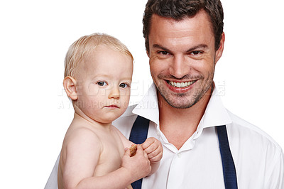 Buy stock photo A doting young father holding his son after a long day at work