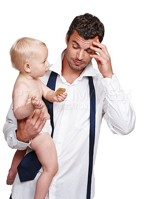 Buy stock photo An exhausted father holding his son after a long day at work