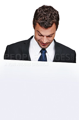 Buy stock photo A handsome young man looking at a placard while isolated on a white background
