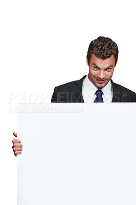 Buy stock photo A handsome young businessman holding a blank board while isolated on white