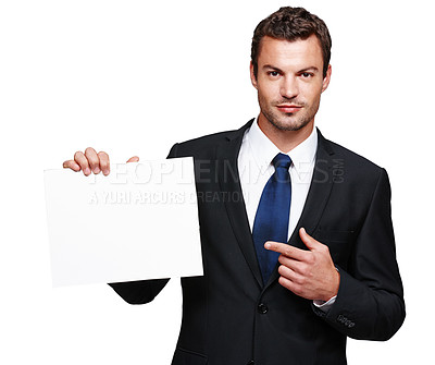 Buy stock photo A handsome young businessman holding a blank placard and pointing at it
