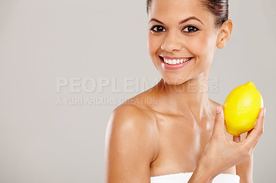 Buy stock photo Woman, vitamin c beauty and lemon in portrait for bright skin, vegan cosmetics and gray background. Female person, mockup space and dermatology for detox, hydration and citrus for facial in studio