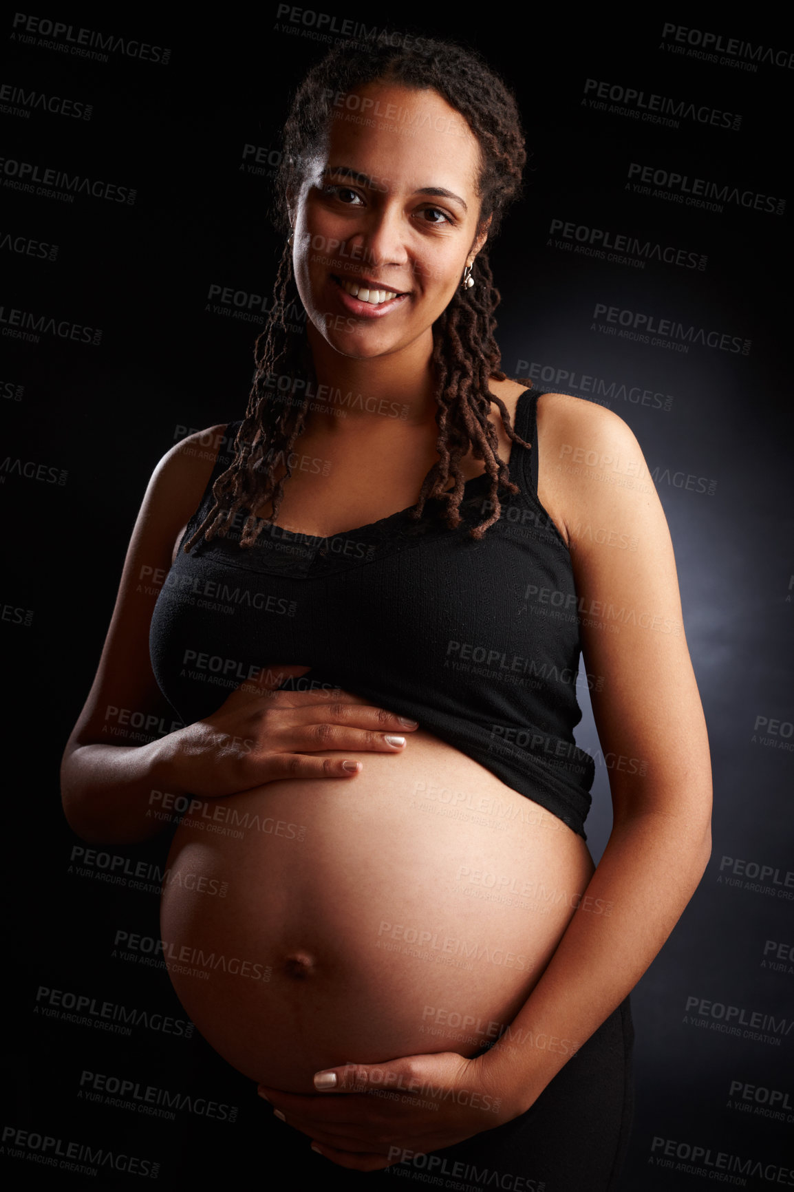 Buy stock photo Pregnant, mom and portrait with belly in studio, baby bump and expectant woman for pregnancy. Black background, gestation and gynecology wellness or family planning, maternity and stomach growth