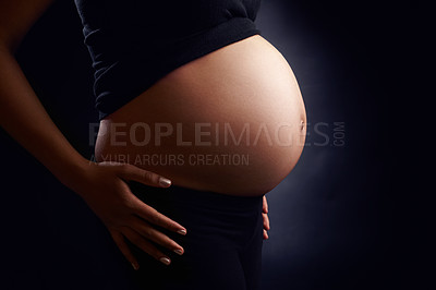 Buy stock photo Woman, profile and stomach for pregnancy in studio with healthy baby growth, love and pregnant person. Body, wellness and mother to be with side view of abdomen, tummy or belly on black background