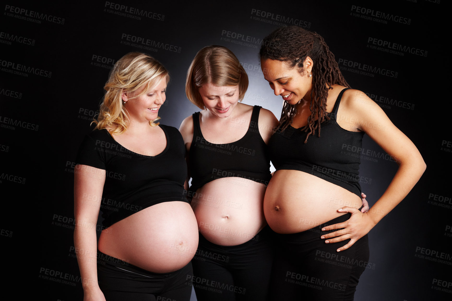 Buy stock photo Pregnant, friends and studio with happy belly, bonding and woman together for stomach growth comparison. Family planning, maternity and pregnancy care, gestation and gynecology on black background