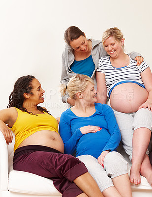 Buy stock photo Group, pregnancy and women on sofa for support, community or prenatal care in living room. Relax, diversity and expectant mother together with stomach growth for body, wellness or maternity in home