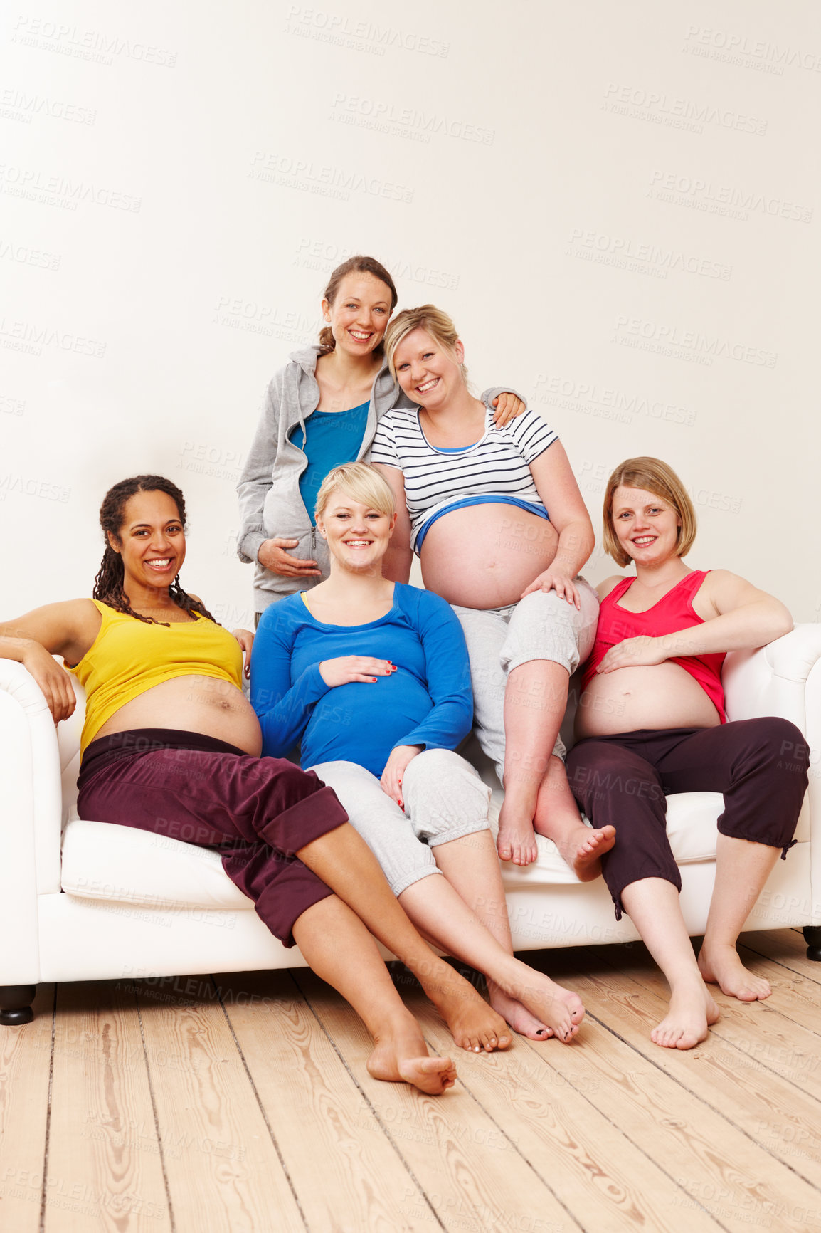 Buy stock photo Pregnancy, woman and group on sofa for relax, friends and unity for support in lounge. Couch, stomach and diversity for growth of children, portrait and together with mom people for community class