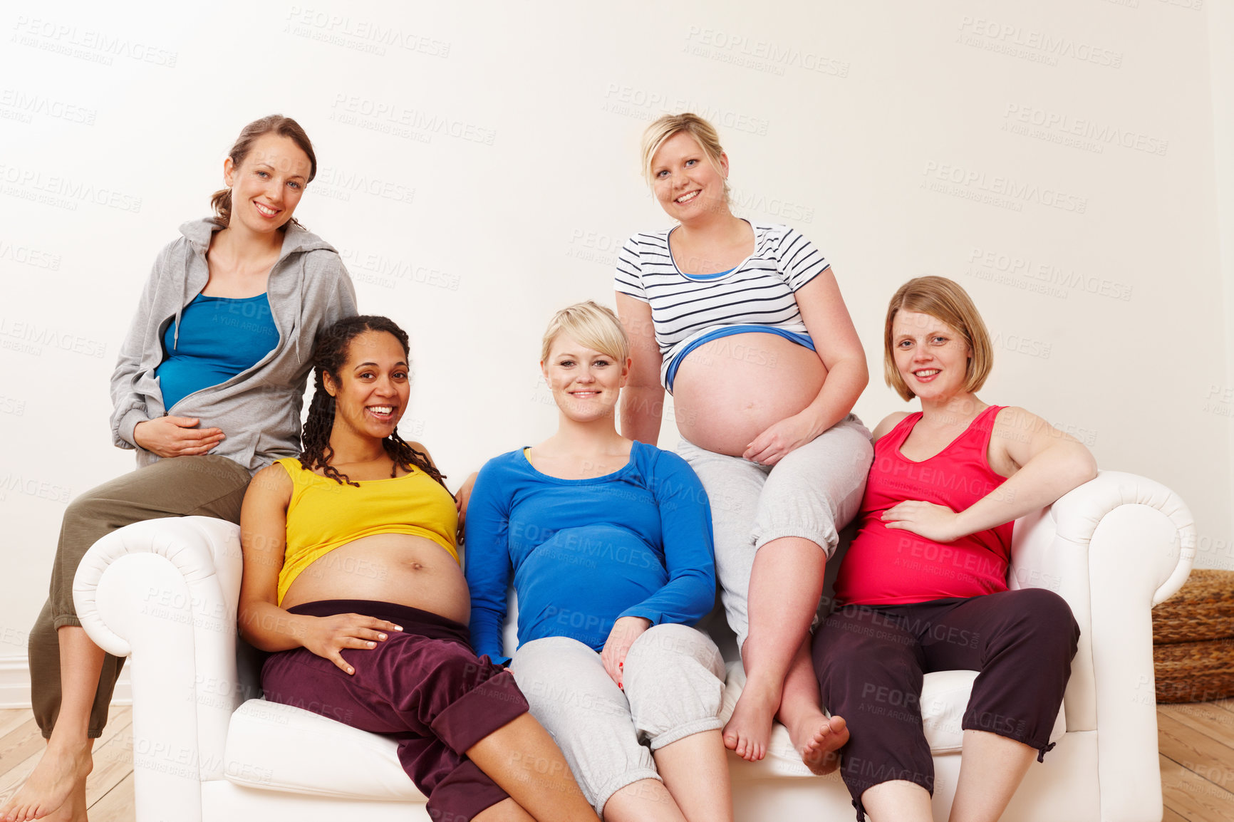 Buy stock photo Pregnancy, woman and group on couch for relax, friends and unity for support in lounge. Sofa, stomach and diversity for growth of children, portrait and together with mom people for maternity class