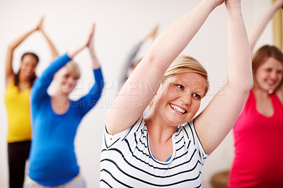 Buy stock photo Pregnancy yoga, smile and stretching with women in class together for exercise, fitness or health. Gym, studio and wellness with group of happy people in pilates routine for maternal community