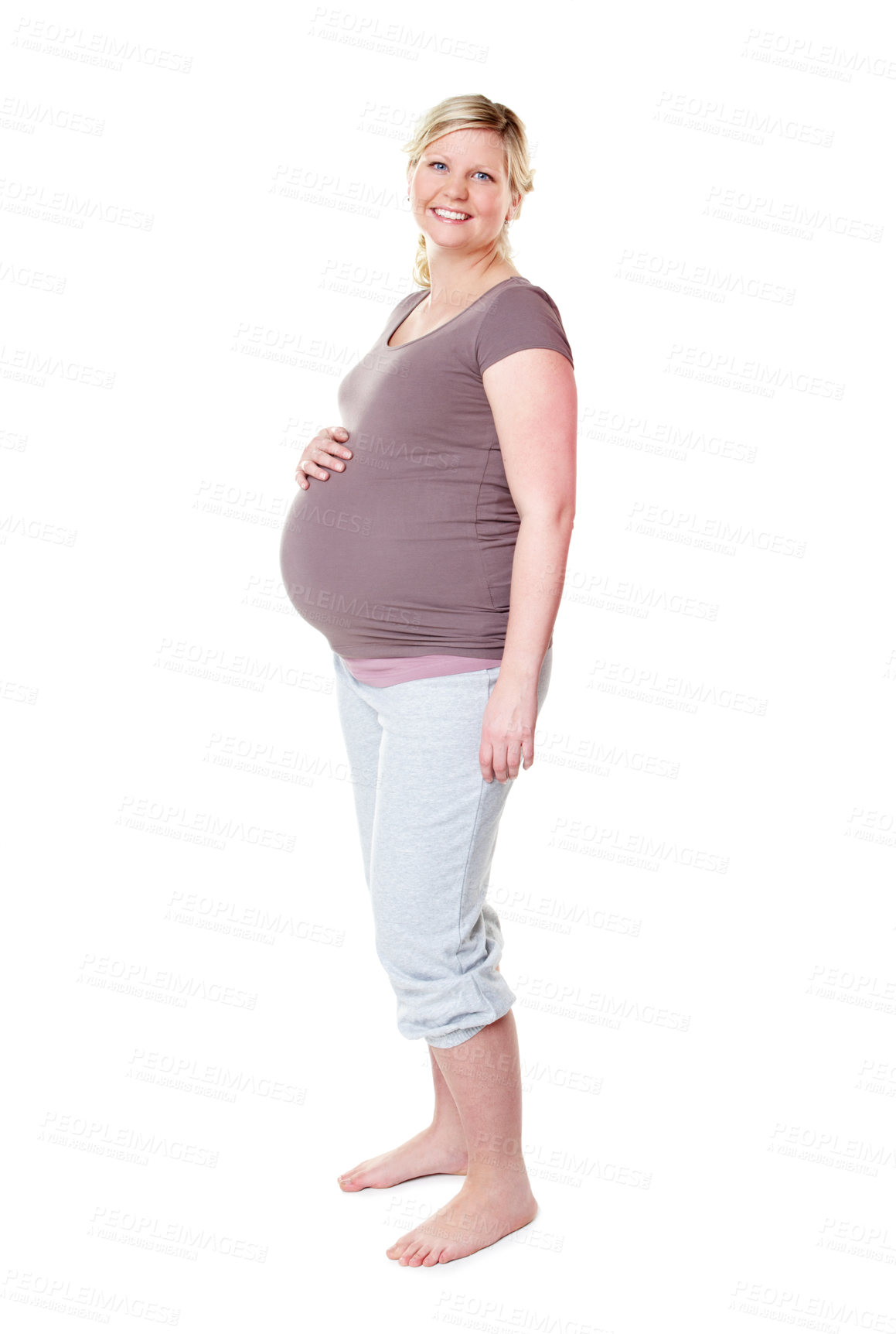 Buy stock photo Pregnant woman, smile and stomach in studio portrait, fashion or excited for baby by white background. Person, happy and ready for motherhood with pride, confidence and maternity clothes for comfort