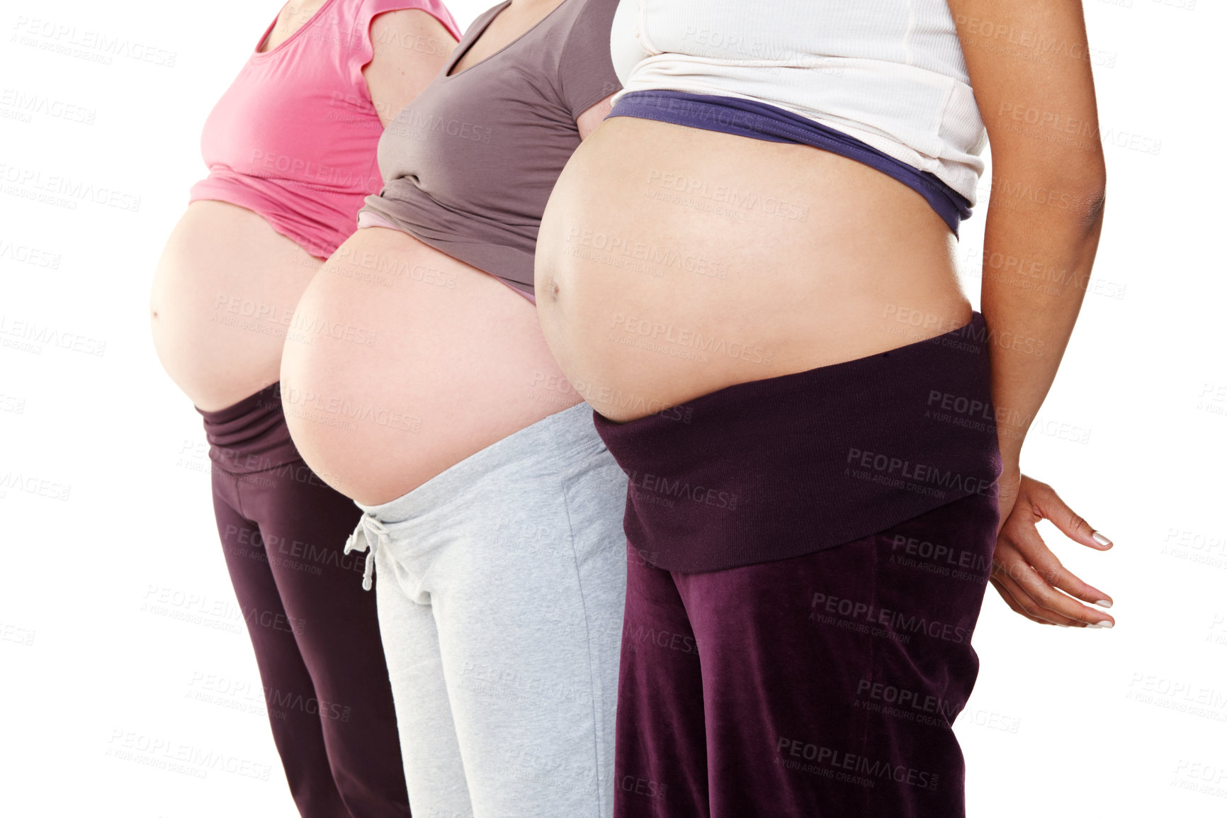 Buy stock photo Closeup of three unknown pregnant women standing close together, isolated on white background in studio. Zoomed baby bump of expecting mothers to be and friends. Posing, showing bare belly and tummy