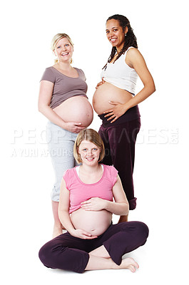 Buy stock photo Pregnant friends displaying their bellies together while isolated on white