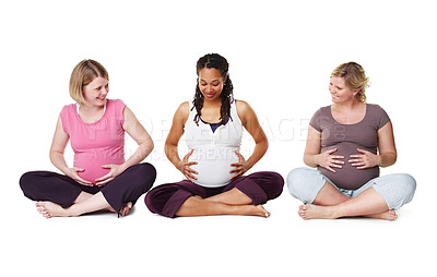 Buy stock photo Pregnant friends sitting together in a row while isolated on white