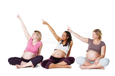 Buy stock photo Friends, women and pregnancy in studio with pointing for advertising, healthy and happy with thought. Female people, white background or presentation with hand gesture for pregnant, mama or diversity