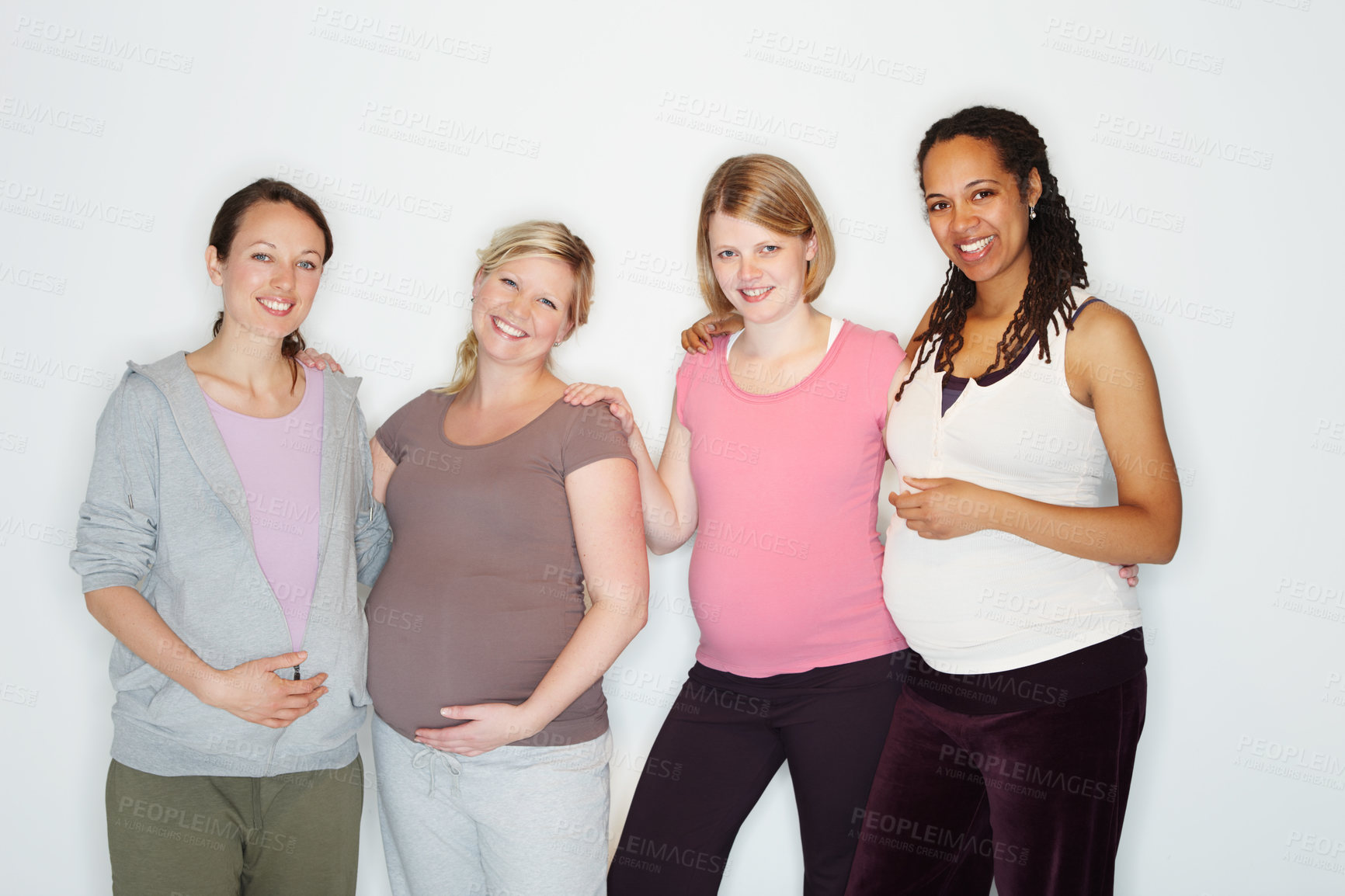 Buy stock photo Pregnant friends standing together while isolated on white