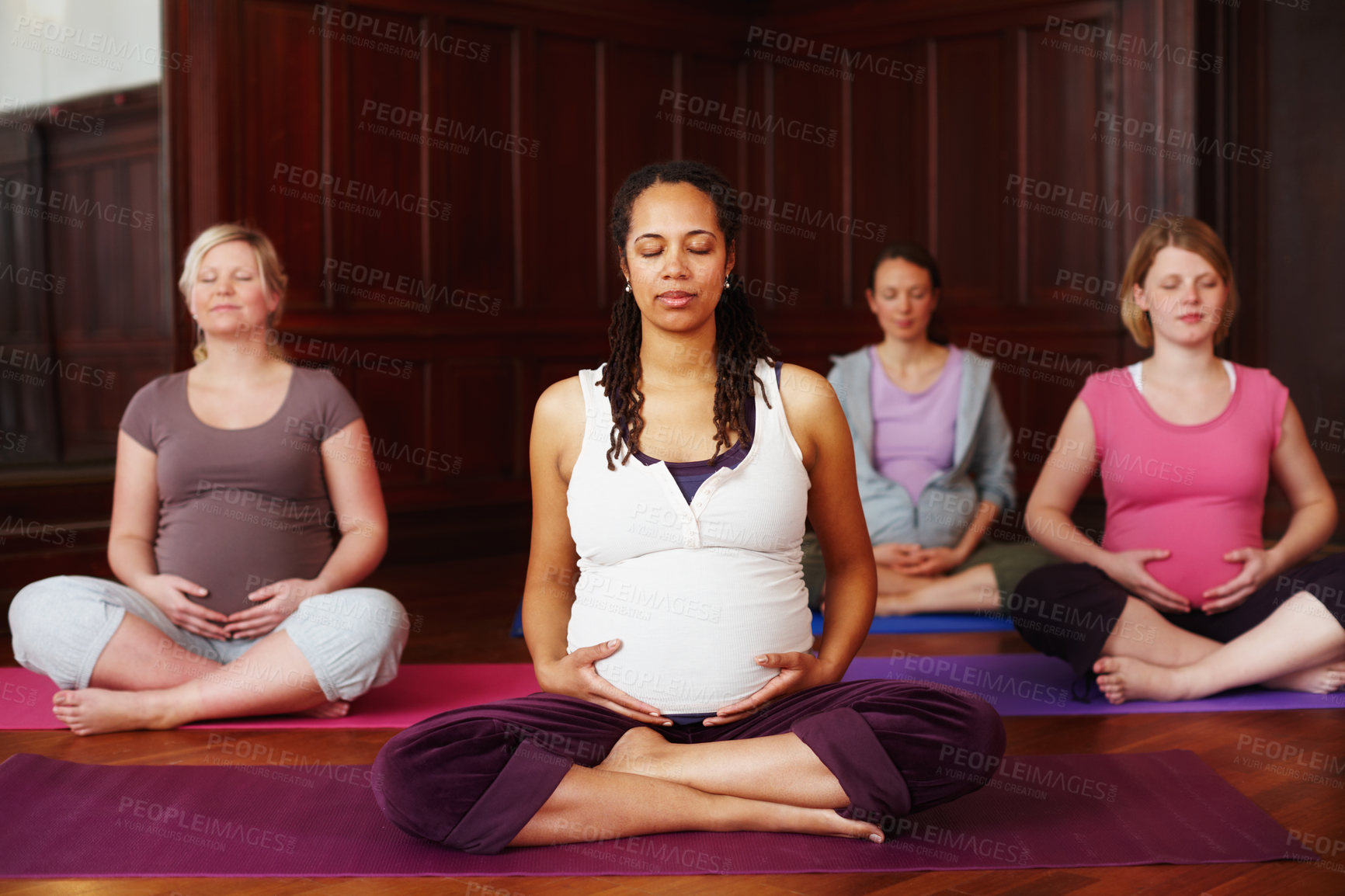 Buy stock photo A group of pregnant women meditating during a yoga class