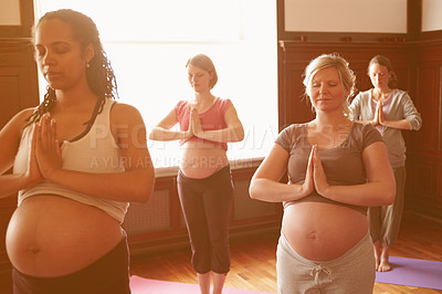 Buy stock photo A group of pregnant women meditating in a yoga class