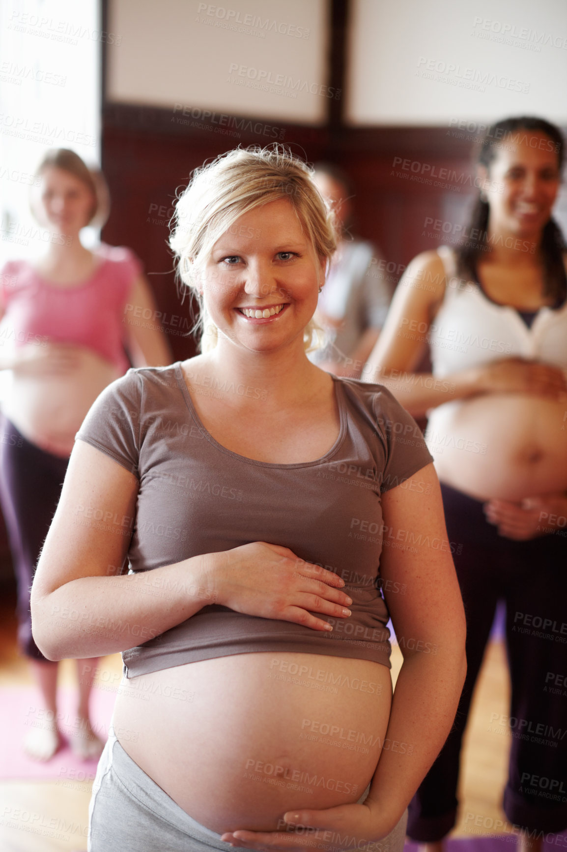 Buy stock photo Smiling pregnant woman enjoying an prenatal fitness class