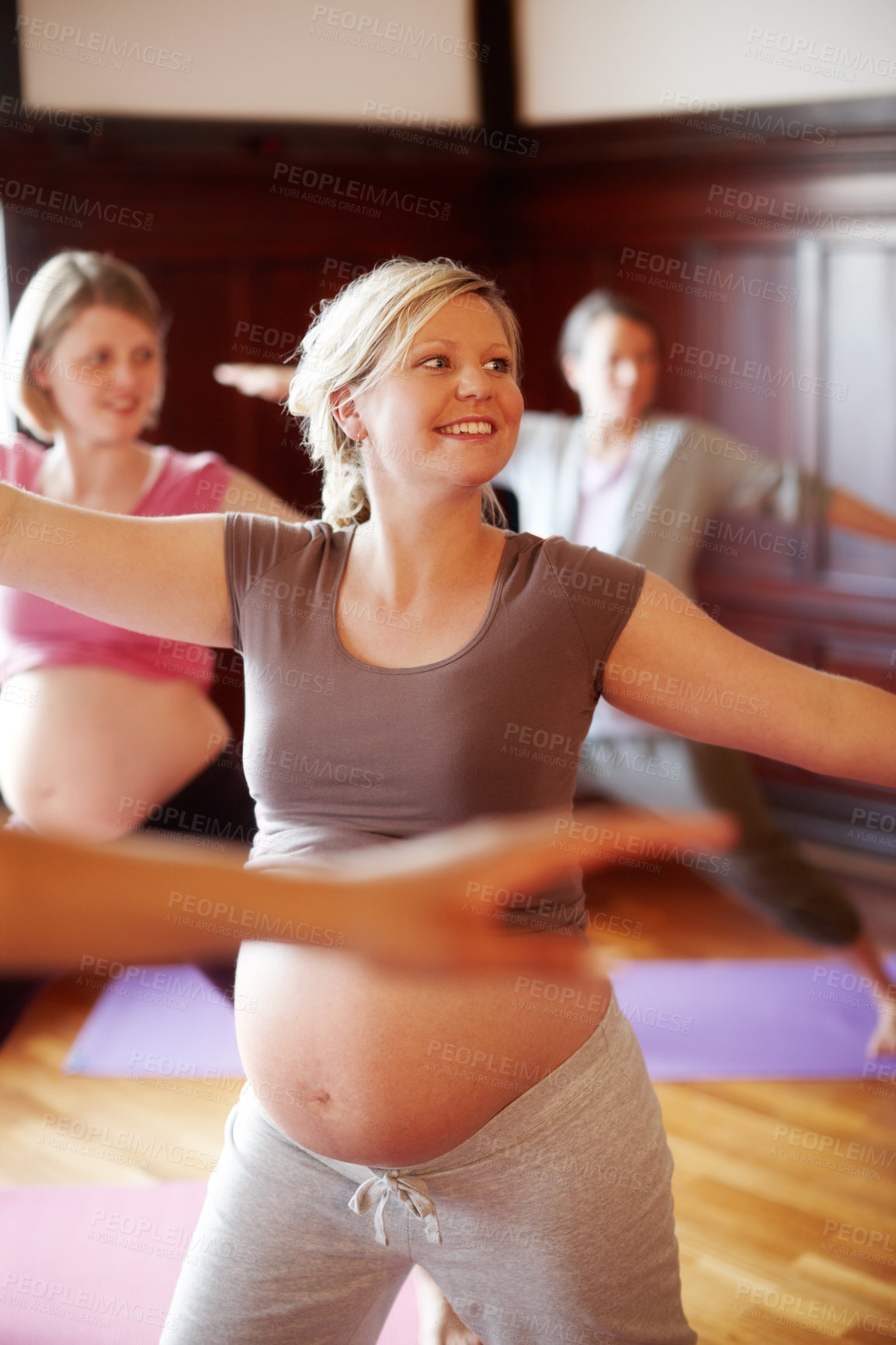 Buy stock photo Fitness, pregnant and wellness women in studio doing cardio exercise in pregnancy community for women. Happy mother to be with abdomen doing pilates or stretching with motivation smile in yoga class