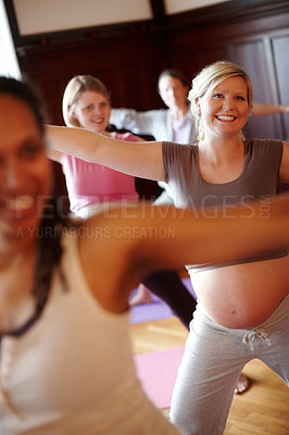 Buy stock photo Pregnant women enjoying stretching during a prenatal fitness class